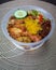 Nasi Ambeng or Nasi Ambang. It is a fragrant rice dish that consists of steamed white rice, chicken curry or chicken stewed in soy