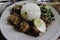 Nasi Campur Ayam Betutu. Balinese roast chicken stuffed with cassava leaves. Accompanied with steamed rice, Sate Lilit, Jukut