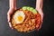 Nasi Goreng - Indonesian Chicken Fried Rice on black plate. Indonesian cuisine dish. Balinese Food. Asian meal