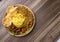 Nasi Kuning or Sego Kuning on wood textured table