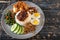 Nasi Lemak is a rice dish infused with coconut cream and laden with deep-fried fish or fried chicken.