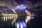 Nassau, Bahamas - June 8, 2019: Beautiful Carnival Liberty cruise ship docked at Prince George Wharf at night. Light reflections