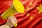 National Chinese flag and a yellow horn in a man`s hand. Speaker, rumors, fakes, information, demonstrations, elections, speaker.