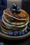 National dish pancakes, pancakes, pita with blueberries, linen napkin, poured with honey, concept of traditional cuisine