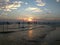 National fishing residents of Sri Lanka who sit on poles near the shore of the evening Indian ocean, looking at the waves, colored