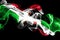 National flag of Burundi made from colored smoke on black background. Abstract silky wave background