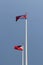 National flag of Cambodia and Philippines on bright blue sky background. Blown away by wind.