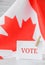 The National Flag of Canada. Canadian Flag or the Maple Leaf with paper note message text. Election day, give vote, your