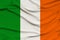 National flag of the country ireland on delicate silk with wind folds, travel concept, immigration, politics, copy space, close-up
