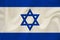 National flag of the country of Israel on gentle silk with wind folds, travel concept, immigration, politics, copy space, close-up
