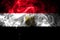 National flag of Egypt made from colored smoke isolated on black background. Abstract silky wave background.