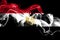 National flag of Egypt made from colored smoke isolated on black background. Abstract silky wave background