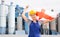 National flag of England in the hands of girl in overalls against background of modern metallurgical plant