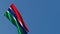 The national flag of Gambia is flying in the wind