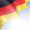 National flag of Germany waving in the wind in the rays of the s