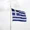 National flag of Greece waving on a mast in stormy weather