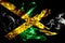 National flag of Jamaica made from colored smoke isolated on black background. Abstract silky wave background.