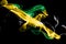 National flag of Jamaica made from colored smoke isolated on black background. Abstract silky wave background