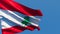 The national flag of Lebanon flutters in the wind against a blue sky