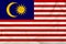 National flag of Malaysia on a silk cloth with folds from the wind, a symbol of tourism, immigration, politic