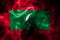 National flag of Maldives made from colored smoke isolated on black background. Abstract silky wave background.