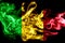 National flag of Mali made from colored smoke isolated on black background. Abstract silky wave background.