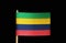 A national flag of Mauritius on toothpick on black background. Consists of four horizontal bands of red, blue, yellow and green