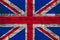 National flag of the modern state of Great Britain on an old historical stone wall, concept of business, tourism, travel,