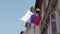 National flag of the republic of Slovenia against the sun and the blue sky waving outside of a apartment. Slowmotion