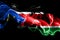 National flag of South Sudan made from colored smoke isolated on black background. Abstract silky wave background