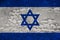 National flag of the state of Israel on an old stone wall with cracks, the concept of tourism, emigration, economy, politics,