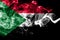 National flag of Sudan made from colored smoke isolated on black background. Abstract silky wave background