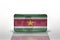 National flag of suriname on the dollar money banknote on the white background