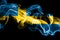 National flag of Sweden made from colored smoke isolated on black background. Abstract silky wave background