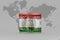 National flag of tajikistan on the dollar money banknote on the world map background .3d illustration