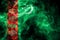 National flag of Turkmenistan made from colored smoke isolated on black background. Abstract silky wave background.