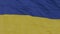 The national flag of Ukraine flutters in the wind on a high flagpole in city. Shooting at close distance range. Real flag in windy