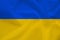 National flag of Ukraine on gentle silk with wind folds, travel concept, immigration, politics