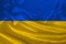 National flag of Ukraine on gentle silk with wind folds, travel concept, immigration, politics, close-up, copy space, illustration