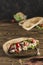 National Greek fast food pita with chicken and fresh vegetables on a wooden Board dark background