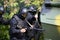 National Guard Special Forces soldiers conduct an operation under the cover of an armored personnel carrier