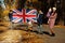National holiday of United Kingdom. Family with british flags in autumn park.  Britishness celebrating UK. Mother with four kids