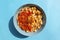 National Kushari in a turquoise plate on blue background