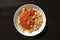 National Kushari in a white plate on dark wooden background