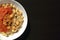 National Kushari in a white plate on dark wooden background with copy space