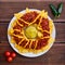 National Mexican and Chilean dish on a wooden table. Homemade potato chips with tomato sauce, beans and minced meat. Mustard sauce