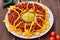 National Mexican and Chilean dish on a wooden table. Homemade potato chips with tomato sauce, beans and minced meat. Mustard sauce