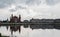 The National Puppet Theatre and  houses reflected in the water in a cloudy day. Yoshkar-Ola city, Mari El, Russia.
