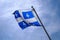 National Quebec flag in Canada fluttering in the wind on blue sky