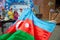 National sign background. The girl put a flag on his shoulder. Azerbaijan tradition patriotic. Flags waving wind . Azerbaijan flag